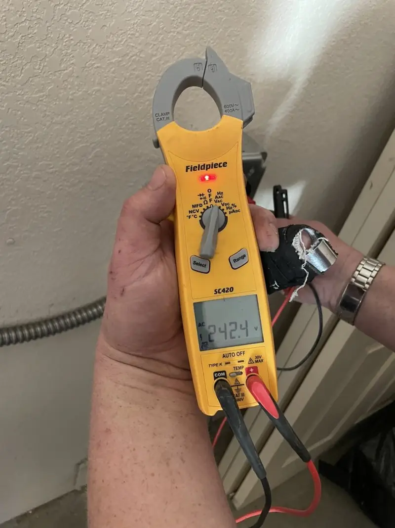Voltage testing with clamp meter during Whole House Surge Protector in Lloyd Harbor